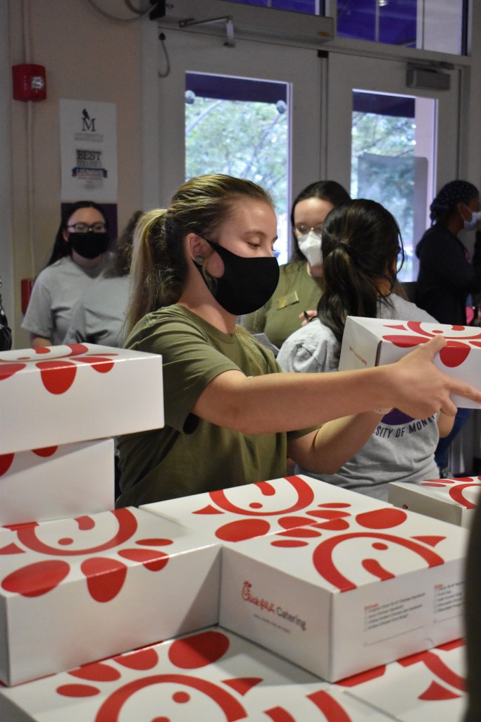 Student Government Association member gives out free Chick-fil-A at W.O.W. Weekend. 