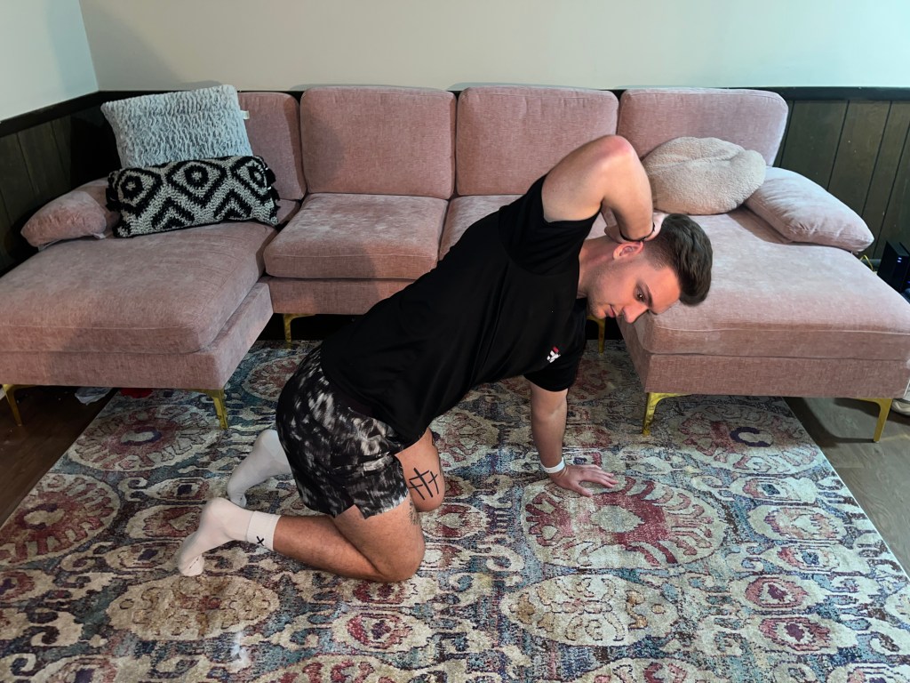 Man demonstrating a t-spine stretch