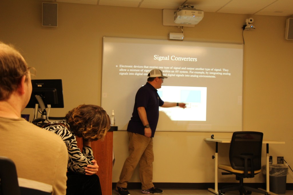 Vest lecturing to video engineering class.