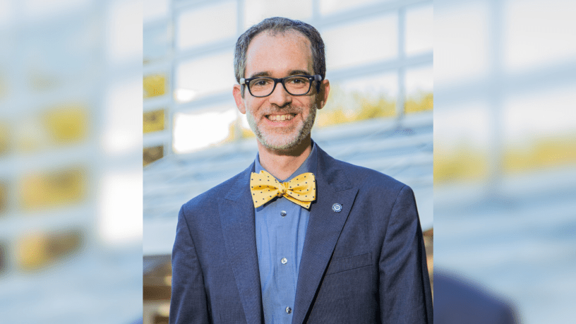 Dr. Sean Atkinson wearing blue suit with bowtie