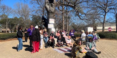 Group of students gathered at statue