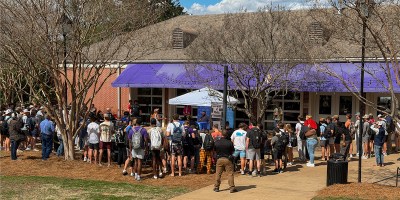 Group of people gathered outside of Farmer Hall