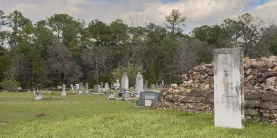 Monument in a grassy cemetery.