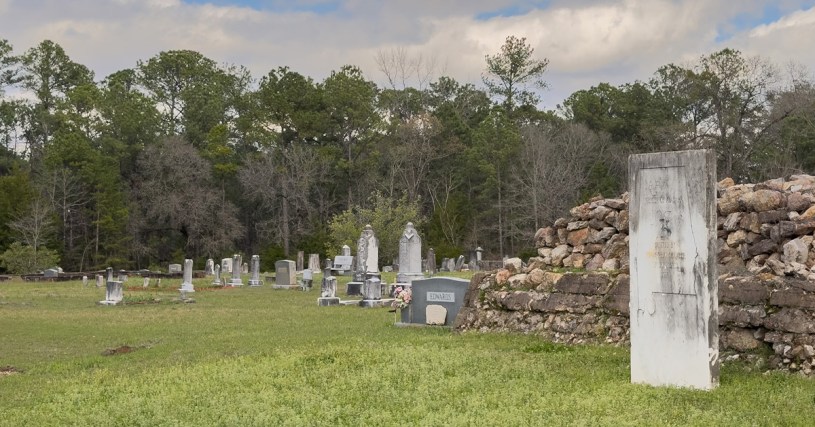 Monument in a grassy cemetery.