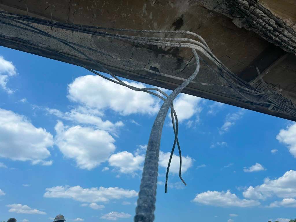 rebar hanging from damaged bridge