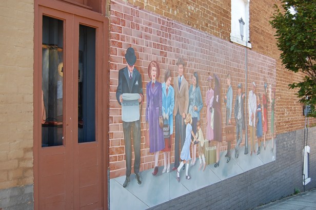 Mural of people in line for phone booth circa 1930s
