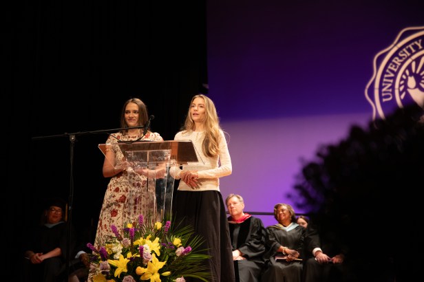 Two women on stage giving a speech