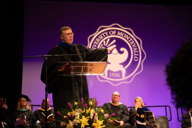 Man on stage giving speech