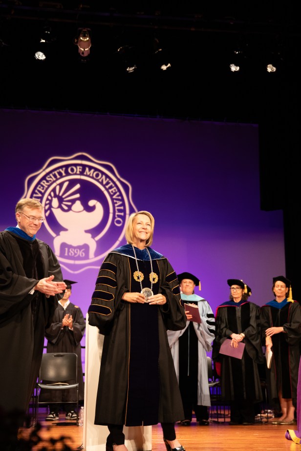 Woman on stage wearing academic regaliz